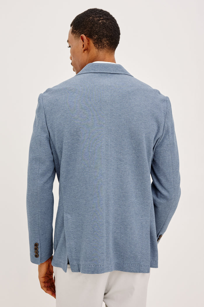 Lorenz Blazer in Nylon With Single Breasted Front Buttons, Single Chest Patch Pocket, Side Patch Pockets, and Long Sleeves in Heather Blue Colorway - Upper body back View Featured on Model