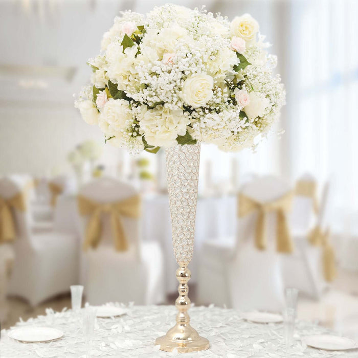 Elegant floral centerpiece with white roses and baby’s breath in a tall vase.