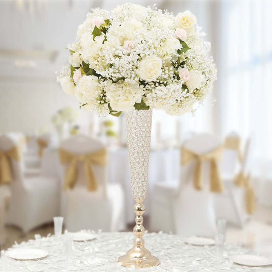 Elegant floral centerpiece with white roses and baby’s breath in a tall vase.