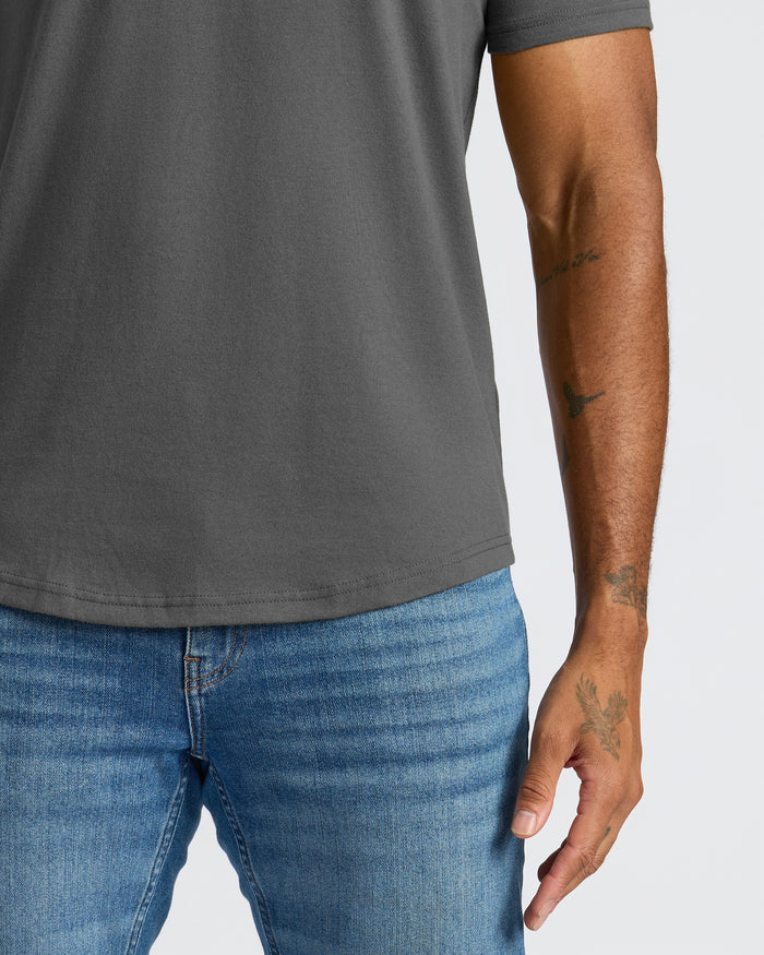 Carbon Curved Hem Classic Crew Neck on person with arm tattoos.