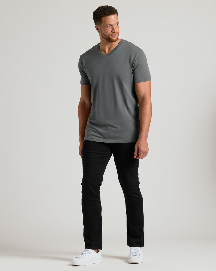 Man wearing Carbon Tall Short Sleeve Classic V-Neck with black pants and sneakers.