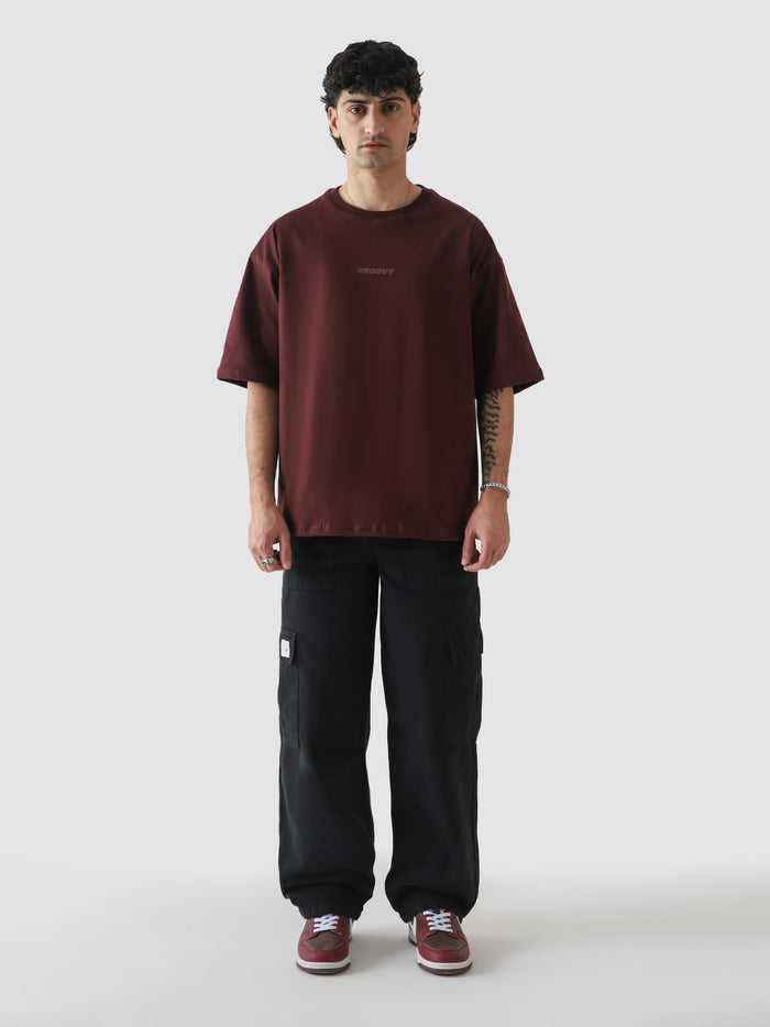 Maroon CORE tee full body front male model oversized fit Pakistan – GROOVY