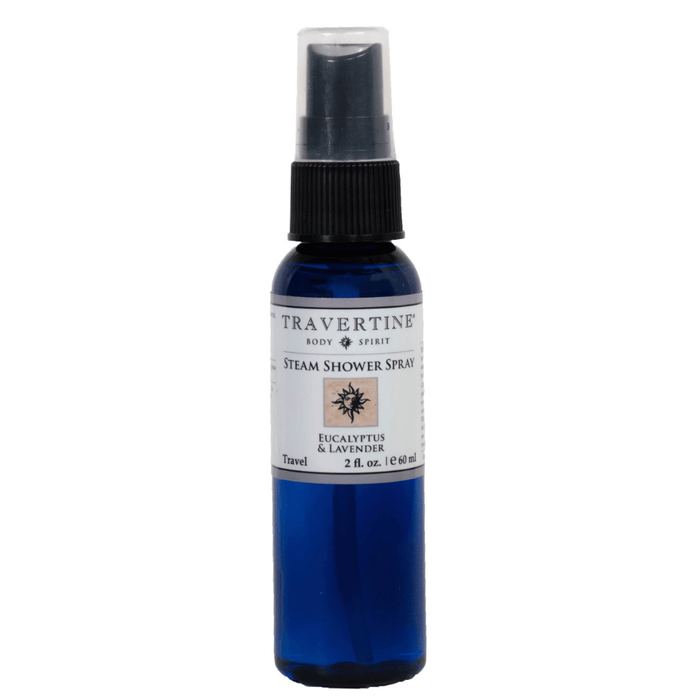 Blue travel-sized spray bottle labeled "Eucalyptus + Lavender Steam Shower Spray | Travertine Spa" designed for enhancing wellness and body care with a refreshing scent.