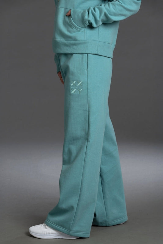 Teal tracksuit with flared pants on a gray background || Underseas