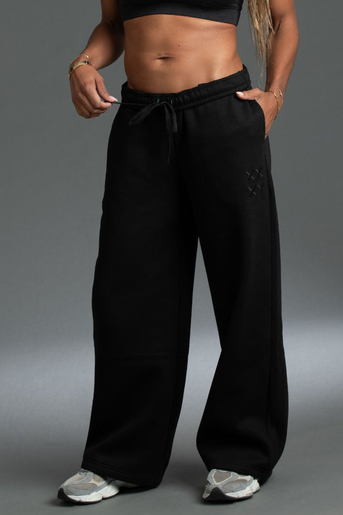 Person wearing black wide-leg pants on a gray background || black
