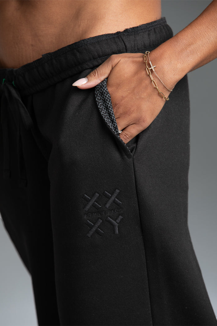 Black pants with a brand logo on a gray background || black