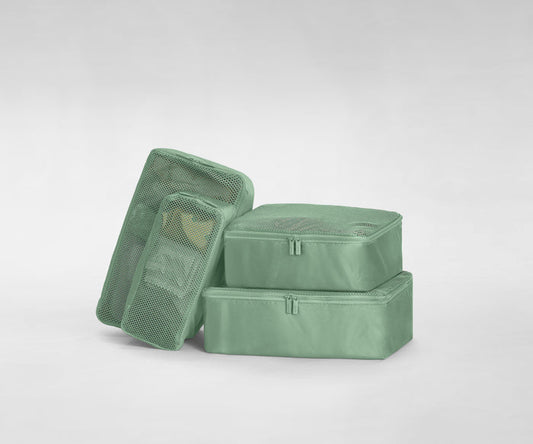 A set of four packed Insider Packing Cubes stacked on top of each other