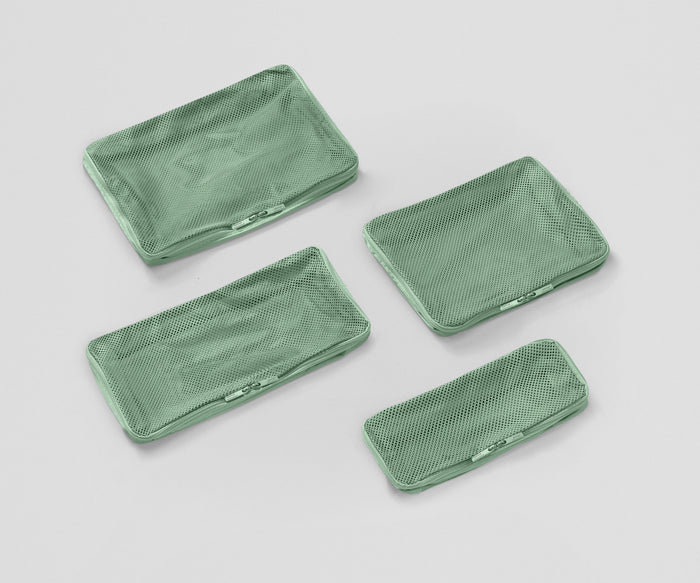 Set of four unpacked Packing Cubes laying flat