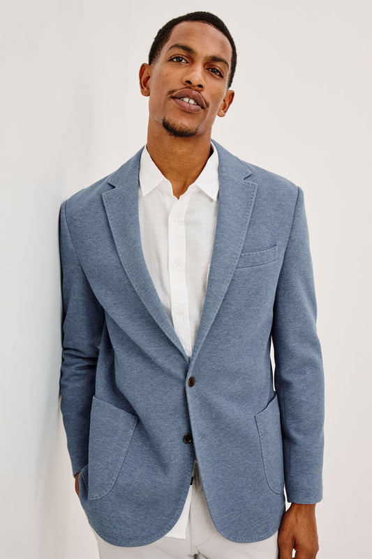 Lorenz Blazer in Nylon With Single Breasted Front Buttons, Single Chest Patch Pocket, Side Patch Pockets, and Long Sleeves in Heather Blue Colorway - Upper Body Front View Featured on Model
