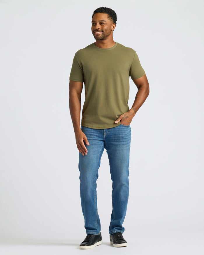 Man modeling Military Green Curved Hem Classic Crew Neck with slim jeans.