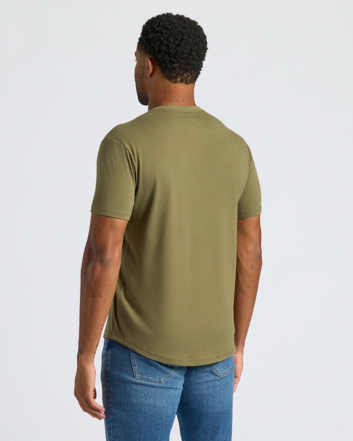 Man wearing Military Green Curved Hem Classic Crew Neck and blue jeans.