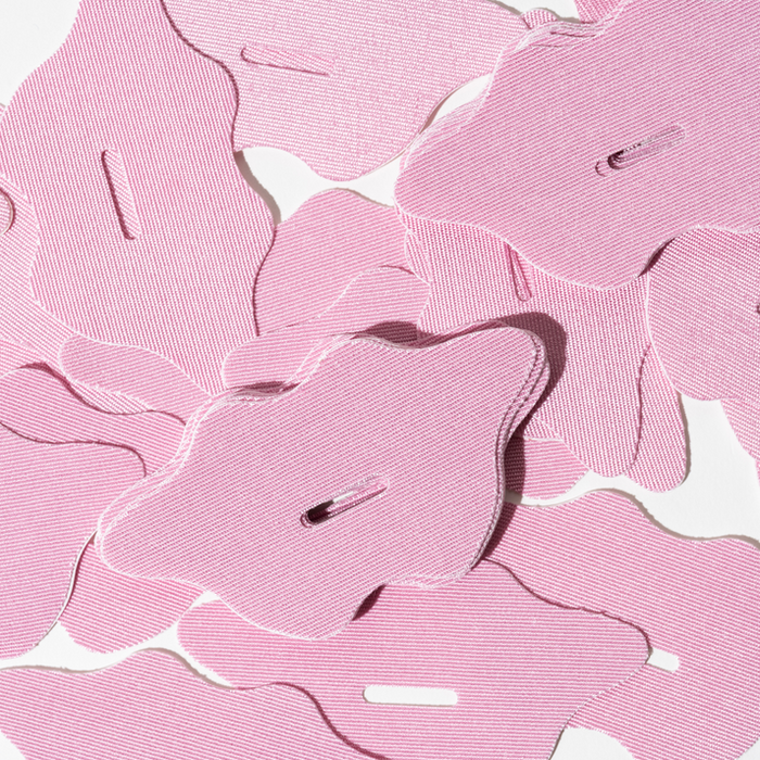 Close-up of multiple pink fabric mouth strips designed for nighttime use, promoting better breathing and wellness as part of Mouth Tape | Dreambox Beauty product line.