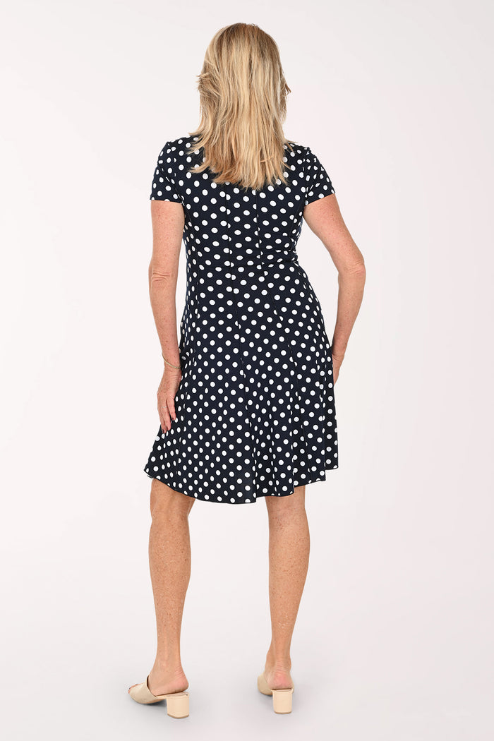 Woman wearing a short sleeve black and white polka dot dress