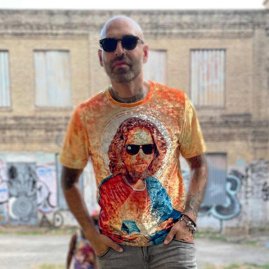 Merging classical religious iconography with a 90s cult cinema aesthetic, this design centers on a painterly portrait of a bearded figure in dark sunglasses (halo included). Contact us with accessibility feedback, we'd love to help!