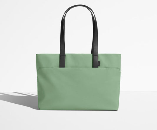 Front view of The Everywhere Tote with its leather handles up
