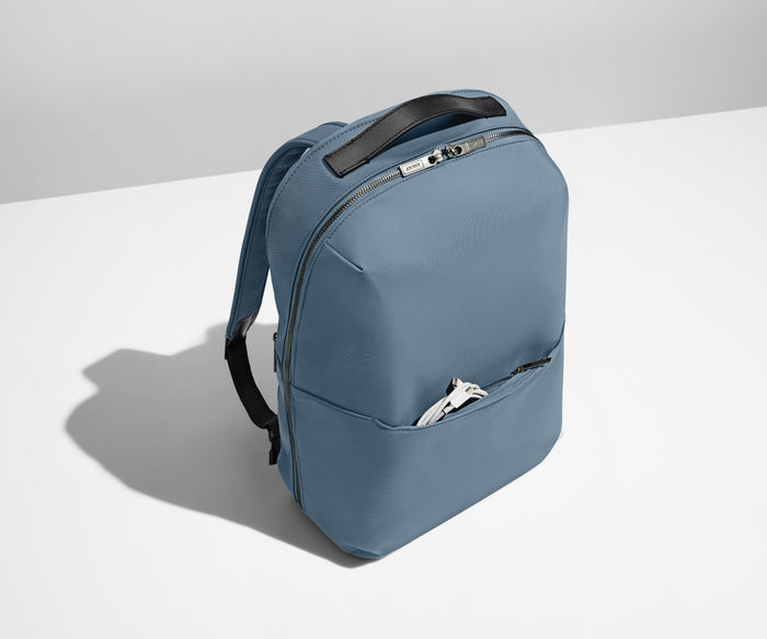 Charging cord packed in the exterior front pocket of the Everywhere Zip Backpack in Coast Blue