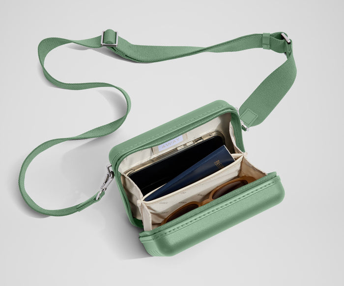The Mini Crossbody packed with a phone, passport, and sunglasses